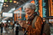 old woman use mobile phone on an airport terminal display background