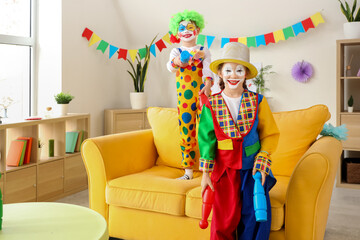 Poster - Funny little children in clown costumes juggling at home. April Fools' Day celebration