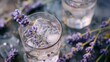 Refreshing gin tonic drinks with lavender and orange slice garnishes, surrounded by warm bokeh lights, suggesting a festive atmosphere.