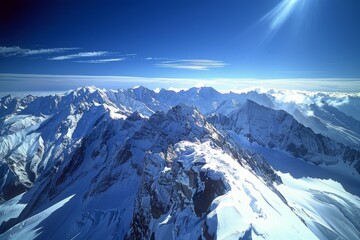 Wall Mural - A panoramic view of the Alps, with snow-covered peaks under a clear blue sky Generative AI