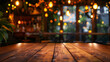 An empty wooden table with a soft glow of lights bokeh set against the blurred ambiance of a cozy restaurant background