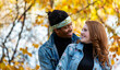 © Designpics - Close-up of a mixed race married couple smiling at each other, spending quality time together during a fall family outing in a city park; Edmonton, Alberta, Canada