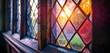 The leaded glass windows of a Tudor Craftsman house, reflecting the sunset in hues of teal and magenta, diverging from the traditional clear and colored glass