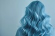 portrait of a beautiful long voluminous wavy blue hair on a girl, viewed from the back,Beautiful girl with hair coloring in ultra sky blue Stylish hairstyle done in a beauty salon. Fashion, cosmetics 