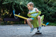 A boy rocking on a spring swing outdoors