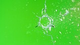 Fototapeta Dmuchawce - Close-up of gunshot through the glass, shattering against the green background