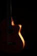 © Robert Peak - Classical Spanish flamenco guitar close up, dramatically lit isolated on black background with copy space.