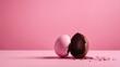 A creatively designed image showing a contrast of a chocolate egg having a pink outer layer, split in half on a pink surface