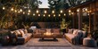 Photo of a cozy outdoor living space with multiple couches and string lights