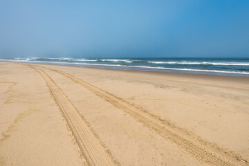 Car tire tracks in the sand of Skeleton Coast, Namibia