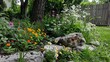 © Janie - Tranquil Garden Corner with Wildflowers and Rocks