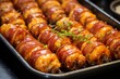 Close up of bacon wrapped tater tots on a serving tray
