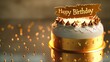 An exquisite birthday cake, elegantly crowned with a gold banner inscribed with 