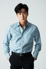 Wall Mural - Asian man dressed in a blue shirt and black pants standing