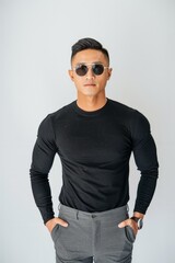 Wall Mural - Asian man is standing wearing a black shirt and grey pants