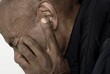 deaf man suffering from deafness and hearing loss on gray background with people stock image stock photo	