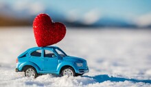 Blue Toy Car With Red Heart On Winter Snowy Background