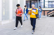 © Xavier Lorenzo - College students using mobile phone after classes while leaving university building campus.