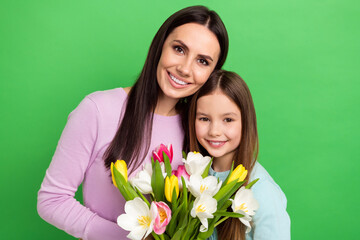 Canvas Print - Photo of sweet cute mommy small girl wear casual outfits holding flowers bunch isolated green color background