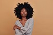 © Katsiaryna - A beautiful black woman with an afro hairstyle poses in front of the camera