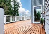 Fototapeta Tulipany - Freshly stain large home walk out cedar wood deck patio