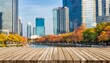 the empty wooden table top with blur background of business district and office building in autumn exuberant image