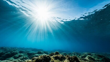 Wall Mural - underwater blue sea background photo with with sun and sunlight shining under the sea