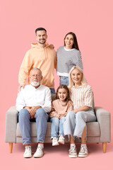 Poster - Big family sitting on sofa against pink background