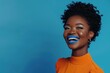 happy African American woman in an orange dress with blue lipstick