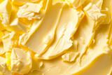 Fototapeta Góry - Closeup view showcases a yellow texture of creamy butter or margarine as background
