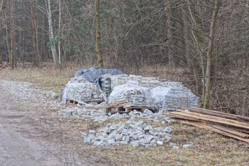 Wall Mural - gray paving slabs in a heap on a pallet standing on the ground in the street