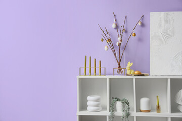 Sticker - Vase with willow branches, Easter eggs and candles on shelf near lilac wall