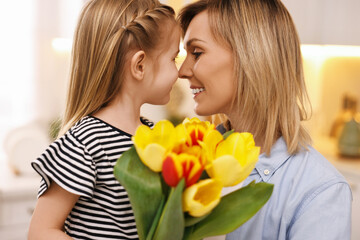 Sticker - Little daughter congratulating her mom with bouquet of beautiful tulips at home. Happy Mother's Day