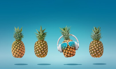 Wall Mural - Summer minimalist pop art composition made with 4 pineapples wearing headphones and listening to music.Minimal concept summer and party.Celebrating the summer vibes.Creative art.Contemporary style.