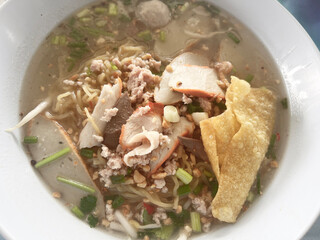 Sticker - noodles soup with pork and vegetables in a bowl