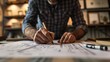 © ISK PRODUCTION - Close-up of architect working on plan in office