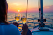 A man and woman are on a boat, enjoying a sunset and drinking wine