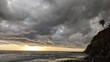 A stormy day sunset - Southern California beach scenes with sunsets, surfers, tide pools and palms trees at Swamis Reef Surf Park Encinitas California.