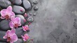 Spa stones and pink orchid flowers on gray background