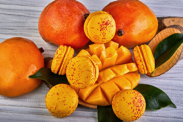 Wall Mural - Assorted natural foods like mangoes and macarons displayed on a table