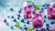 Blueberry juice in glasses on a minimal pastel background