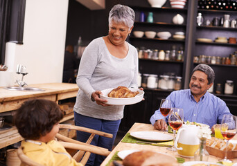 Poster - Happy, big family and turkey with child for thanksgiving dinner, meal or food at the table. Grandparents, little boy or child with smile for dining, eating or lunch in happiness together at the house