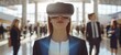 Virtual reality experience. Businesswoman with VR headset standing in a conference hall with blurred background figures.