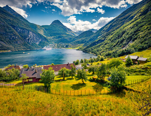 Wall Mural - Sunny summer view of Geiranger port with huge peak on background, western Norway, Europe. Stunning morning scene of Sunnylvsfjorden fjord vith cruise liner. Traveling concept background.
