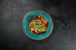 © Ryzhkov - Asian salad with chicken and vegetables in ceramic bowl on dark concrete background. Salad with chicken, muer mushrooms and green onion in chinese cuisine style. Asian menu in minimal style on black.