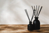 Fototapeta Na sufit - Minimalist Aromatic Reed Diffusers on a Wooden Surface Against a Soft Background