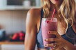 Close up young sport woman holding healthy smoothie