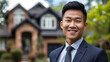 Smiling asian male real estate agent with a beautiful house in the background