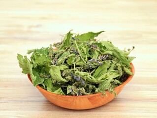 Dried Scutellaria lateriflora, known as  blue skullcap or mad dog skull cap  in the basket.  Herb is used in traditional medicine, originating from America.