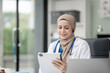 © Phushutter - Portrait of Muslim middle age female doctor with head scarf in white lab coat and stethoscope while consult online in laptop. advice on good mental health management and medical treatment costs.